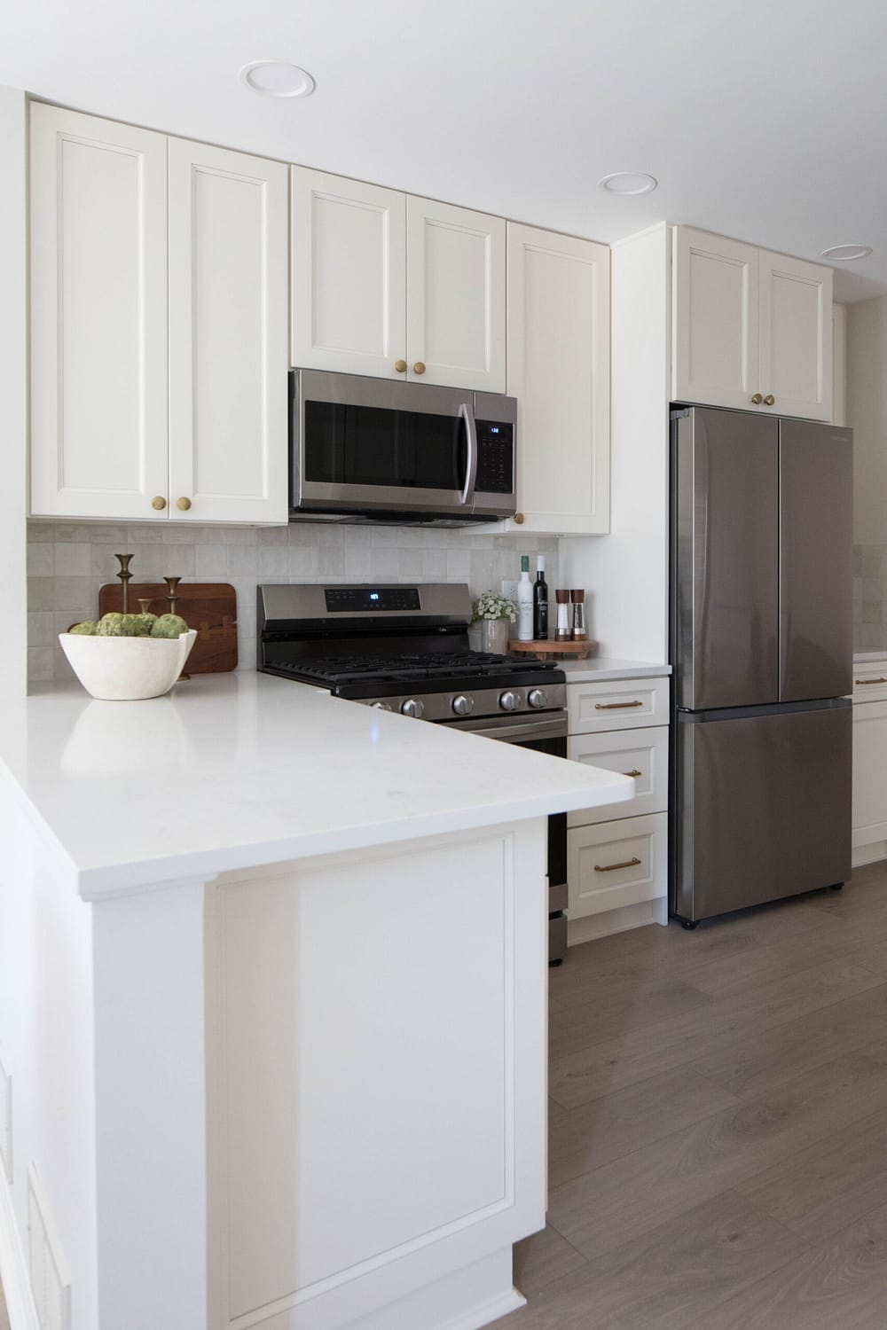 Apartment kitchen with white cabinets and quartz countertops