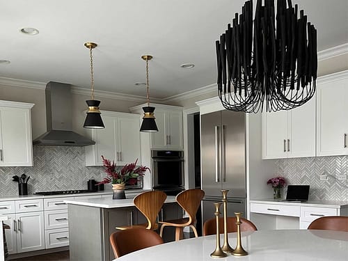 Traditional kitchen with white cabinets and black accents designed by Dara Agruss Design