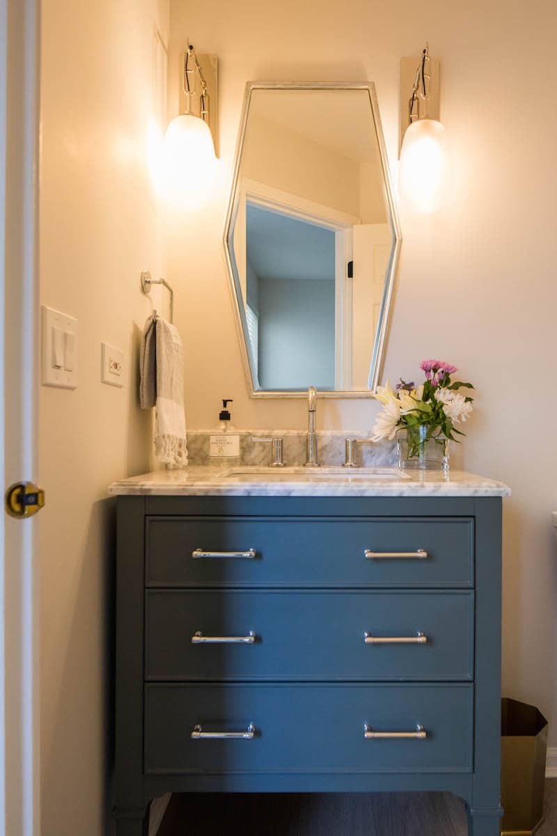 Washroom sink with blue cabinets