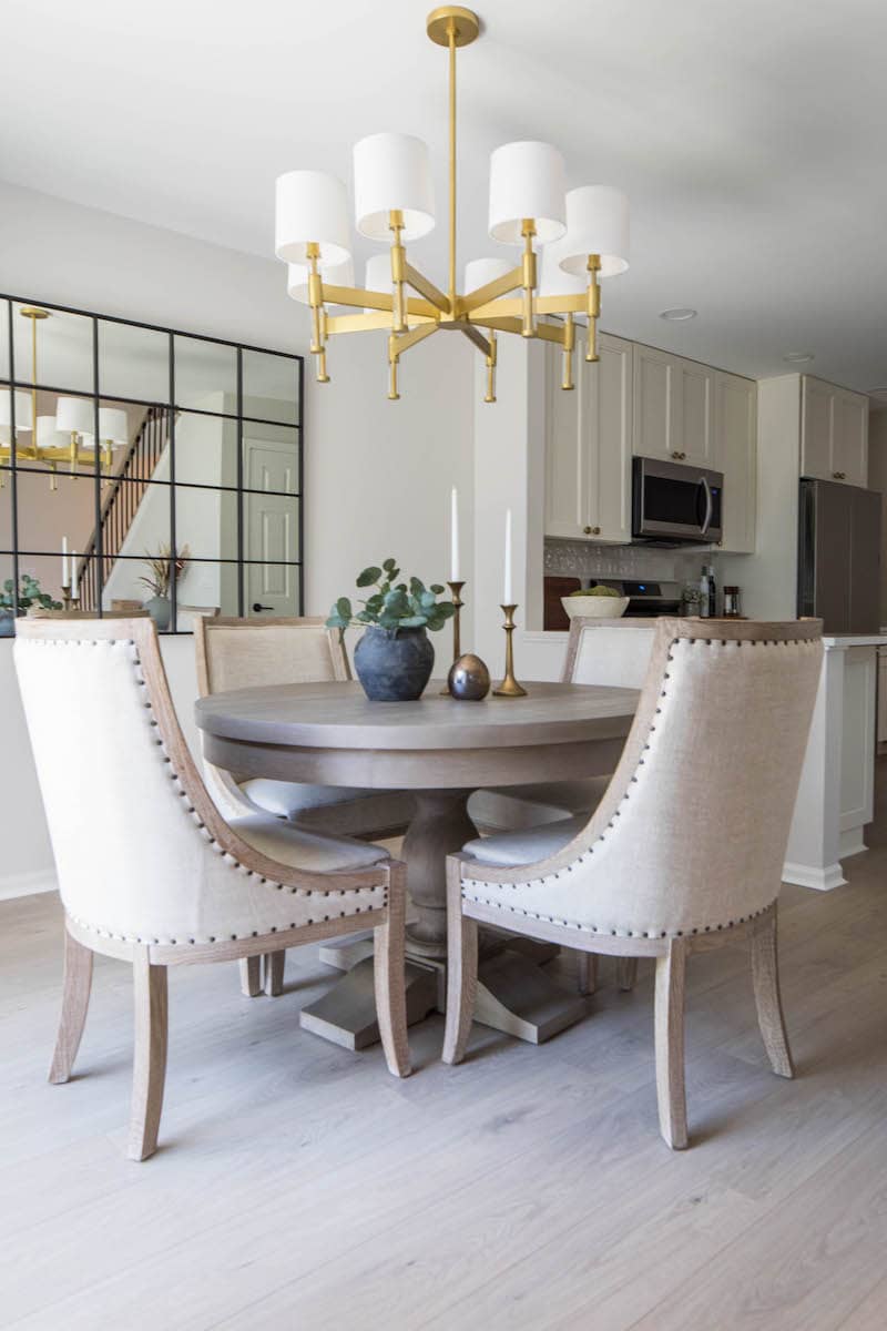 Apartment dining room with cushioned dining chairs and round table
